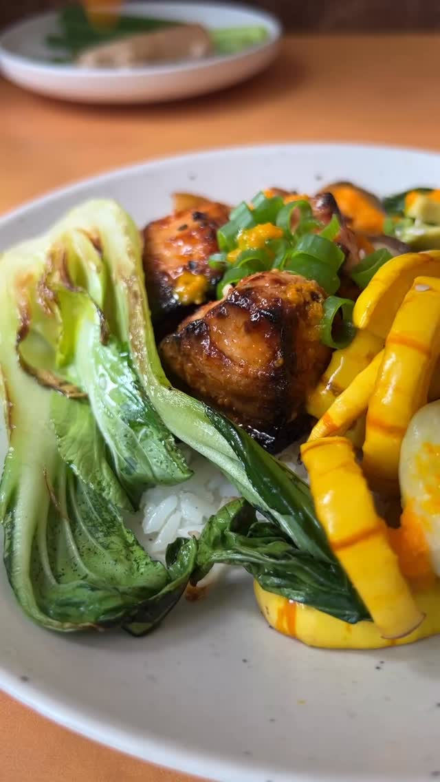 Air Fryer Miso Glazed Salmon Bowl with King Oyster Mushrooms, Seared Bok Choy and Delicata Squash 
(Serves 2)

1 medium delicata squash
4 oz. King Oyster Mushrooms
2-3 baby bok choy, halved
Air Fryer Miso Glazed Salmon Bites (comment SALMON for the recipe) 
Carrot Ginger Salad Dressing (recipe below)

1. Roast the delicata squash: Preheat oven to 400°F and line a sheet pan with foil or parchment. Cut squash crosswise, scoop out seeds, and slice thin (skin is edible). Toss with 1 tbsp neutral oil + ¼ tsp kosher salt, spread evenly, and roast 20–25 min until golden and tender.
2. Sear king oyster mushrooms: Slice lengthwise into thick planks, heat a drizzle of neutral oil in a skillet, and sear 2–3 min per side until browned. Remove from pan.
 3. Sear the bok choy. Rinse the baby bok choy and pat it dry thoroughly.  In a 10-in skillet over medium-high heat, warm oil until shimmering. Place bok choy cut-side down and lower the heat to medium. Press gently and let sear for 2–3 minutes until golden. Flip over and cook for another minute. 
Finally, prepare the Air Fryer Miso Glazed Salmon Bites (comment SALMON for the recipe). Serve salmon and veggies over rice and drench with Carrot Ginger Dressing. 

Carrot Ginger Salad Dressing 
(Makes appx. 1 qt):

1lb carrots (6 medium), peeled + sliced into coins no larger than 1/4 inch thick
2 inch piece of ginger, peeled + sliced into 1/4 inch pieces
3 peeled garlic cloves
2 scallions, whites only, sliced
1/2 cup SEASONED rice vinegar (if using plain rice vinegar, I recommend adding 1 1/2-2 tbsp of honey or sugar to sweeten the dressing)
1/2 cup water
1 tbsp soy sauce
1 tbsp toasted sesame oil
1/2 cup neutral flavored oil like avocado or grapeseed
Kosher salt

Place half the carrots, ginger, garlic, scallion, vinegar, water, and soy sauce into a quart sized receptacle (like a mason jar or a large deli container) and blend using an immersion blender until smooth. Add the remaining carrots and blend.  Drizzle in oils and season to with  Kosher salt. Consume within 4 days for optimal freshness. #thesaladwhisperer