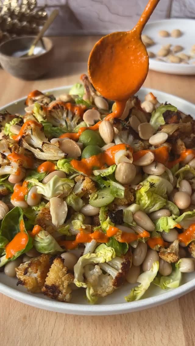 DAY 18 of the 24 DAYS OF DRESSING! Romesco-ish Dressing recipe below! Also, comment BOOK for a chance to win one of the 24 free copies of my cookbook: Salad Whisperer. 

Caramelized Cauliflower Brussels Sprout and White Bean Salad with Romesco-ish Dressing
10 brussels sprouts
1/2 tsp granulated garlic
1/2 tsp smoked paprika 
1/2 tsp Kosher salt & more for seasoning salad
1/8 tsp sugar
1 large head cauliflower
2-3 tbsp olive oil
1 can white beans, I used Great Northern Beans, rinsed/drained
1/2 cup marcona almonds, chopped
1/2 cup sliced castelvetrano olives
 5 fres thyme leaves, for garnish
Romesco-ish Dressing
�Cut a V-shaped notch from the base of each Brussels sprout to remove the core. Smash each sprout 3–4 times with a heavy pot, separate into leaves, wash, dry, lightly salt, and set aside. Mix garlic, smoked paprika, salt, and sugar. Place a large sheet pan on the middle rack and preheat oven to 450° (F).�Cut cauliflower into 1-inch florets, rub with olive oil, and toss with the spice mix. Carefully remove the hot pan, add cauliflower (listen for the sizzle), and return to oven. Roast 26 minutes total, flipping once. Key step: once or twice during roasting, briefly crack the oven door to release steam (lean away so steam doesn’t hit you in the face). This keeps the cauliflower searing, not steaming. Cool cauliflower 5–10 minutes. Coarsely chop Brussels sprouts and add to a large bowl with cauliflower, beans, almonds, olives, and dressing. Season to taste and finish with thyme.

Romesco-ish Dressing 
4 oz. (appx. 1/2 cup) roasted red peppers, drained 
3 tbsp Sherry vinegar
2 tbsp marcona almonds
1 peeled garlic clove
1 tbsp honey
4 tbsp extra virgin olive oil
4 tbsp room temp water
Kosher salt
Black pepper 
1/2 tsp smoked paprika

Using an immersion blender or a top loading blender, blend together the roasted red pepper, vinegar, almonds, garlic, and honey. With blender running, drizzle in the oil and water, alternating, 1 tbsp at a time, until the dressing is smooth. Season to taste and stir in paprika. 
#thesaladwhisperer #saladrecipes #recipeadventcalendar