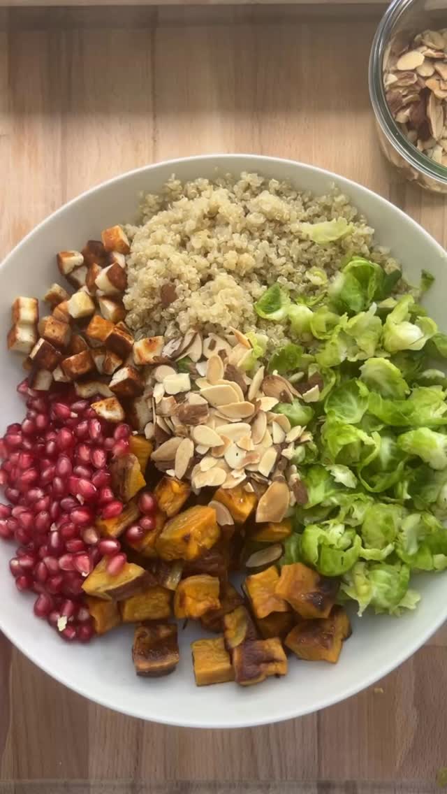 Roasted Sweet Potato Brussels Sprout & Quinoa Salad with Pomegranate & Halloumi

1/2 lb Brussels sprouts (about 10-12 med sprouts) 1 lb. sweet potatoes Kosher salt 1 1/2 tablespoon olive oil, divided 1/3 cup raw sliced almonds
3/4 cup pomegranate arils 1 cup cooked quinoa, room temperature 2-3 oz. halloumi 

Trim the ends of each sprout and make a small v-shaped cut into the base to remove the core. Place the sprouts on a cutting board and, using a sturdy fry pan or heavy bottomed pot, gently smash them one at a time until they flatten and begin to separate into individual leaves. Transfer the Brussels sprout leaves to a large bowl, sprinkle with about 1/2 tsp salt, and toss well. Let them sit while you prepare the rest of the salad.
Prepare a sheet pan with parchment paper and preheat oven to 400° F. Cut sweet potatoes into 1/2 inch dice. Coat sweet potatoes with 1 tbsp oil and sprinkle with Kosher salt. Roast until golden brown, about 35 min. Cool to room temperature. Reduce the oven temp to 350°F. Spread the sliced almonds on a small baking sheet and toast on the middle oven rack for 10-12 minutes, stirring once halfway through, until golden and fragrant. Cut the halloumi into small crouton-sized cubes and toss with remaining 1/2 tablespoon of olive oil. Heat a nonstick skillet over medium heat, then add the halloumi in a single layer. Cook for 1–2 minutes per side, turning as needed, until golden brown on all sides. Transfer to a plate to cool. In a large bowl, combine Brussels sprouts, sweet potatoes, pomegranate arils and cooked quinoa. Add the toasted almonds and halloumi croutons. Drizzle with the dressing and toss gently to coat. Season to taste.

Maple Dijon Dressing

1 tbsp Dijon mustard 1 1/2 tbsp maple syrup 1/4 cup Apple Cider Vinegar  1 garlic clove, grated 5 tbsp neutral oil (grapeseed or avocado) 5 tbsp extra virgin olive oil S&P

Whisk together the mustard, maple, and vinegar until fully dissolved. Drizzle in the neutral oil first, then the olive oil, in a slow steady stream, to emulsify into the dressing. Whisk in the garlic and season to taste. 
#thesaladwhisperer